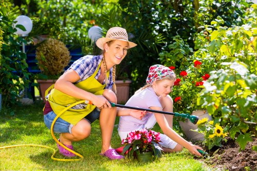 Gardener using equipment carefully in a landscaped garden